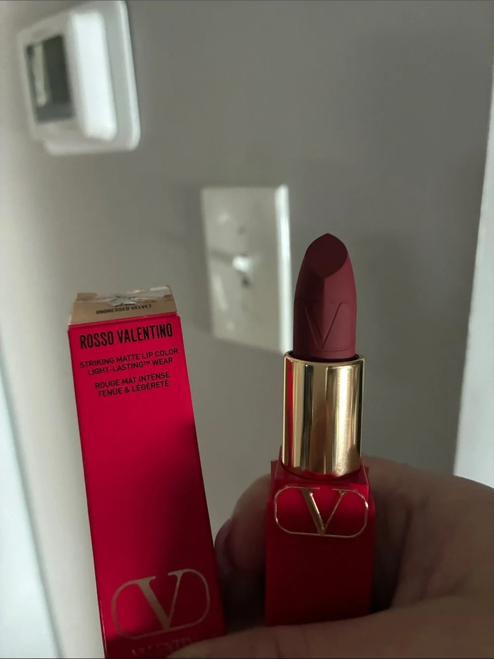 Valentino red lipstick with gold V-logo hardware